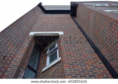 Tall brick building with perspective from underneath