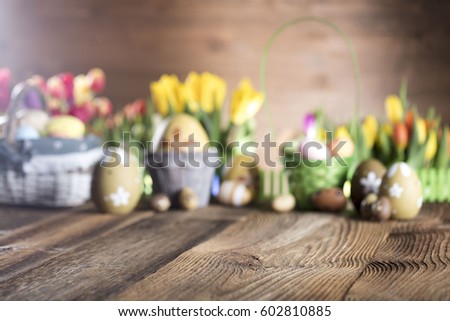 Easter eggs. Colorful bokeh, place for typography and logo. Rustic wooden table. Easter theme. Royalty-Free Stock Photo #602810885