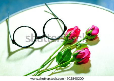 Rose petals arranged in a heart shape, Concept valentine. eyeglasses