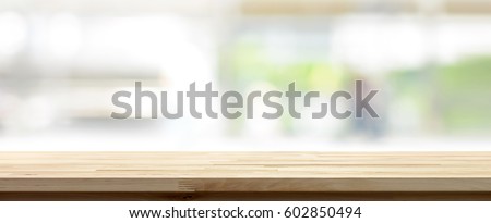 Wood table top on blur white green kitchen window background, panoramic banner - can be used for display or montage your products (foods)