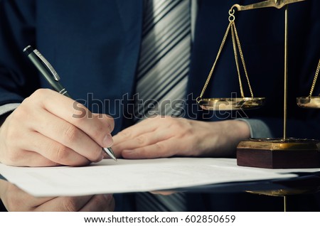 Lawyer working with agreement in office. man signing hand writing pen attorney concept Royalty-Free Stock Photo #602850659