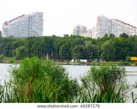 City park with a lake and high buildings in Europe