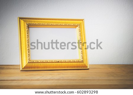 Gold photo frame on wood desk