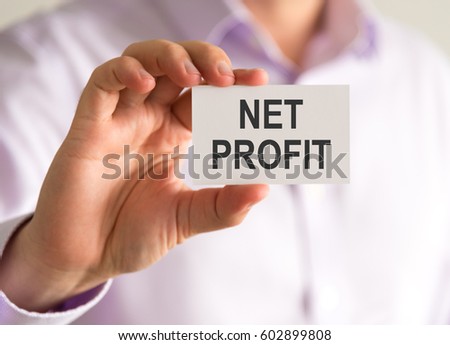 Closeup on businessman holding a card with NET PROFIT message, business concept image with soft focus background