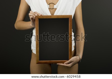 Wooden frame in hands. Ready for your message or picture.