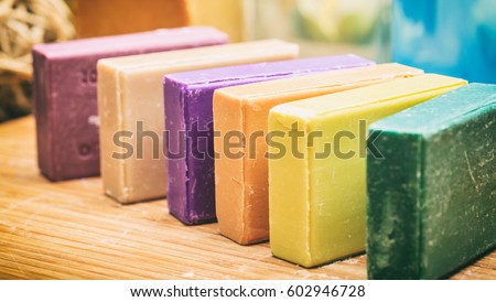 Homemade soaps. Variety of colorful handmade soap bars on wooden background Royalty-Free Stock Photo #602946728