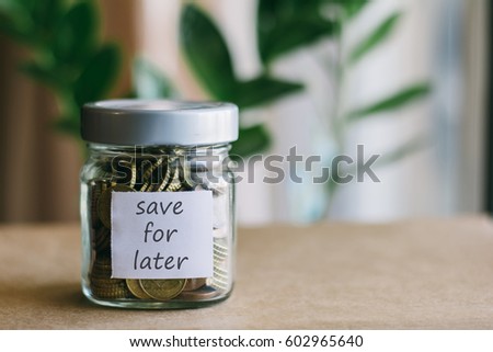 money in the glass with the word 'SAVE FOR LATER' written Royalty-Free Stock Photo #602965640