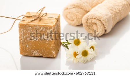Natural handmade soap bar and chamomile on white background