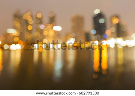 Reflection blurred bokeh light city office building night view, abstract background