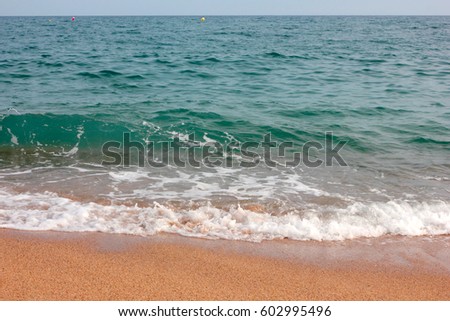 Strip of coastal sandy beach and calm waves of the Mediterranean Sea