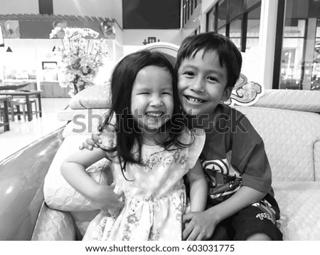 black and white picture of lovely young Asian brother and sister portrait with fun 