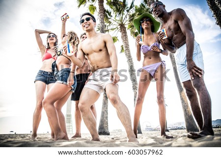 Group of friends making big party on the beach