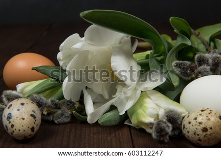 Easter eggs and flowers on a brown table

