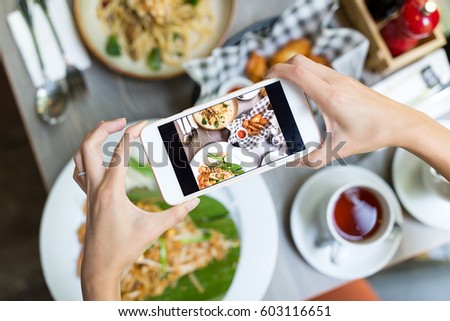 Top view of woman taking photo with cellphone