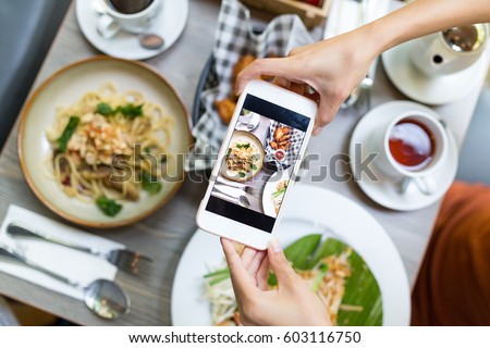 Top view of woman taking photo on dishes
