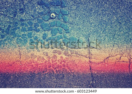 Color toned cracked asphalt background of texture.