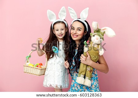 easter, family, holiday and child concept - close up of little girl and mother coloring eggs for easter. Royalty-Free Stock Photo #603128363