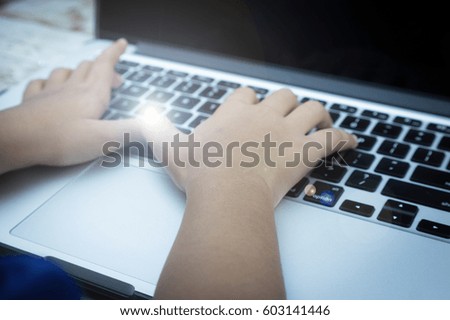 Hand on keyboard with flare effect, information, connection, communication, and technology concept