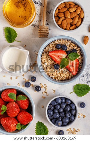 Healthy breakfast - a bowl of oatmeal, berries and fruit, top view.
