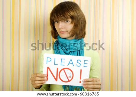 Young girl holding a sign with the text: Please do not smoke