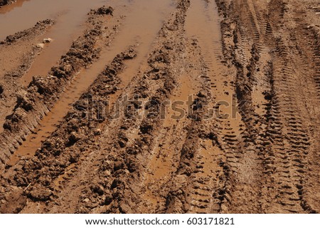 Traces of wheeled vehicles used in agriculture on a dirt road