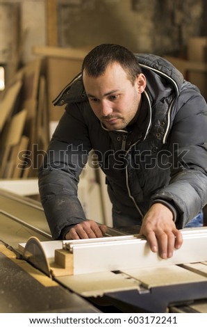Man doing some carpentry work in a workshop. 