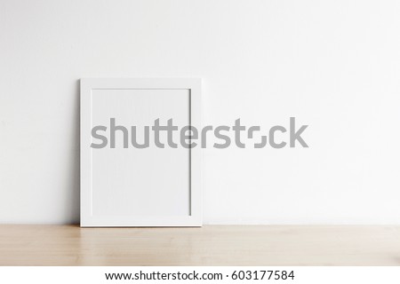 Blank frame photo on wood table with copy space