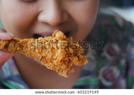 Picture blurred abstract background of table in fat woman eat fried chicken
