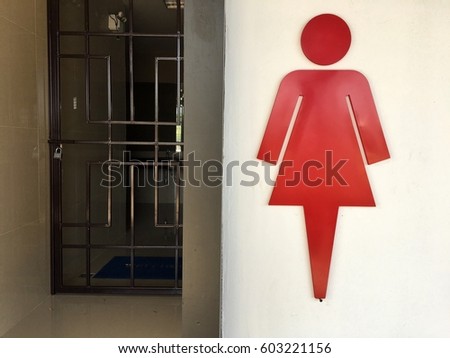 Female toilet symbol and enter door.