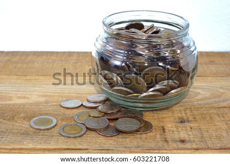 Mix coins and seed in clear bottle on white background,Business investment growth concept
