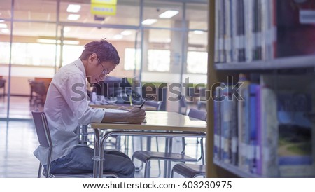 student in Library Royalty-Free Stock Photo #603230975