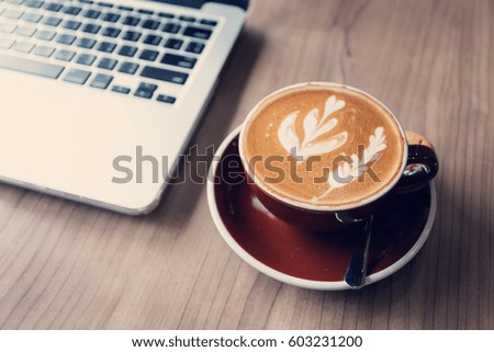 Cup of coffee on workplace desk, coffee cafe shop.