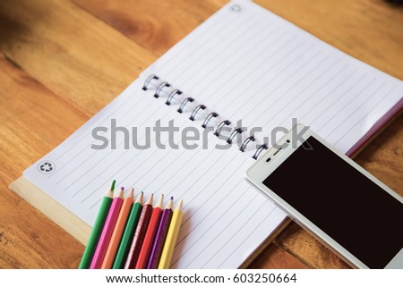 Student's desk with blank holiday phone