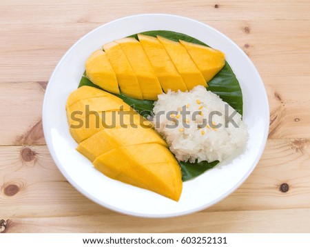 Mango sticky rice. Thai style dessert, mango with glutinous rice on wooden table background.