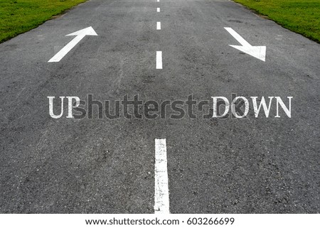 Opposite arrow on the asphalt road with text up and down.