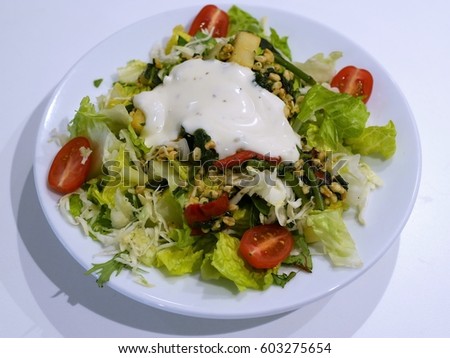A plate of salad with dressing