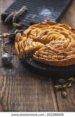 Homemade apple pie on a wooden tray