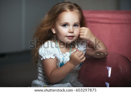 Children's portrait of a girl in the house, apartment.