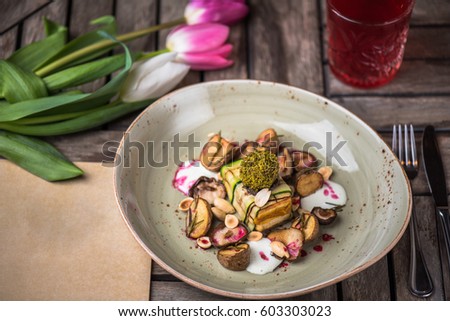 Appetizer of cheese and vegetables, flowers and drink on a wooden table close-up. Healthy food. Vegetarian food. Royalty-Free Stock Photo #603303023