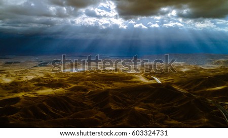 this picture was taken in the mountains of Israel with a professional drone, the morning sun sends light through stormy clouds, shortly after the rain came