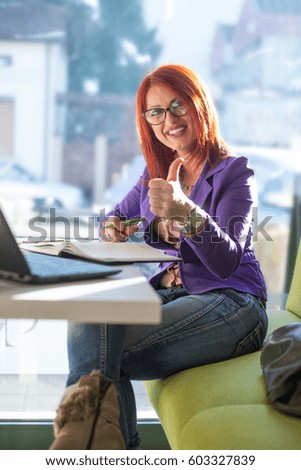 Business woman in coffee break.Under exposed photo