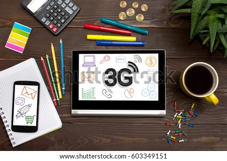 Tablet with web icon 3G on a wooden table with office tools.Businessman touching icon wireless connection. 