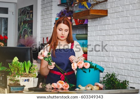 attractive young girl working in a flower shop
