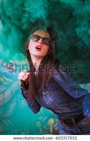 Fun with torch. Portrait of a Girl in the smoke. green smoke