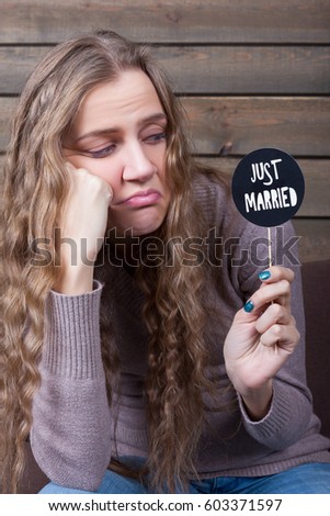 Woman with disgusted face holding icon on a stick