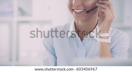 portrait of a customer service agent sitting at office Royalty-Free Stock Photo #603406967