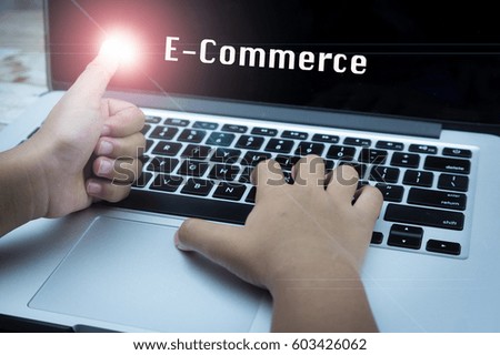 Thumb up Hand on keyboard with flare effect and text E-COMMERCE, information, connection, communication, and technology concept