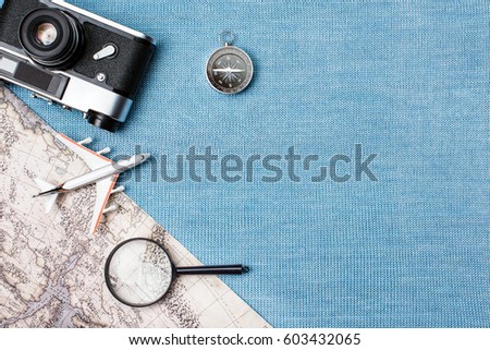 Travel accessories on blue knitted background, travel concept. Top view