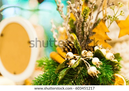Christmas Fir Tree Toys Old wooden star hanging on branch Burning Candles, Boxes, Balls, Pine Cones, Walnuts, Branchesin the background other decorations and garlands. copy space.