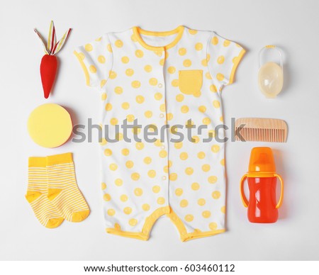 Baby clothes and accessories on white background